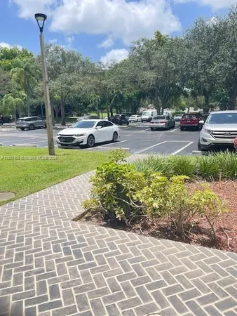 a view of a street with a cars parked on the road