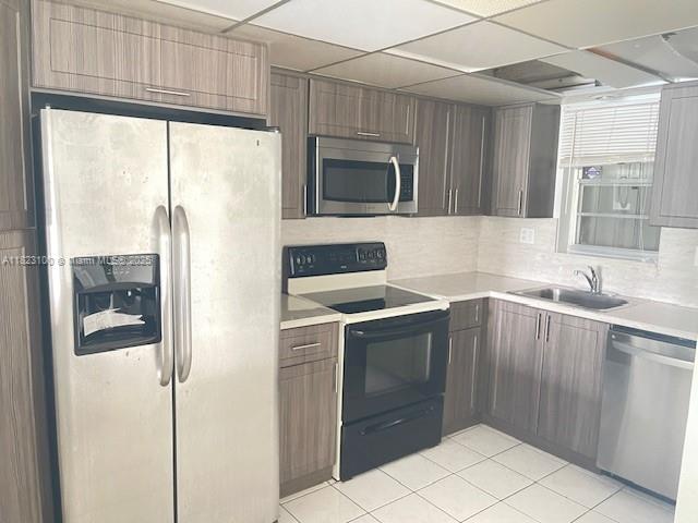 3100 West Rolling Hills Circle, Unit 101 Davie, FL 33328 - Photo 6 of 12 a kitchen with a sink cabinets and stainless steel appliances
