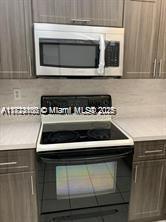 3100 West Rolling Hills Circle, Unit 101 Davie, FL 33328 - Photo 7 of 12 a stove top oven sitting inside of a kitchen