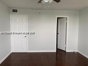 3100 West Rolling Hills Circle, Unit 101 Davie, FL 33328 - Photo 9 of 12 an empty room with wooden floor