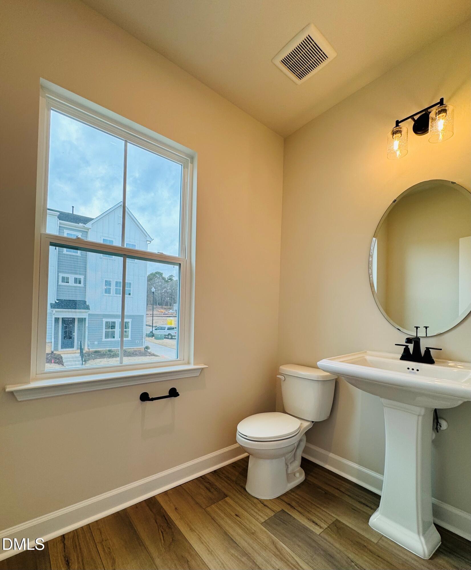 802 Hyperion Alley Wake Forest, NC 27587 - Photo 16 of 67 a bathroom with a toilet sink and mirror