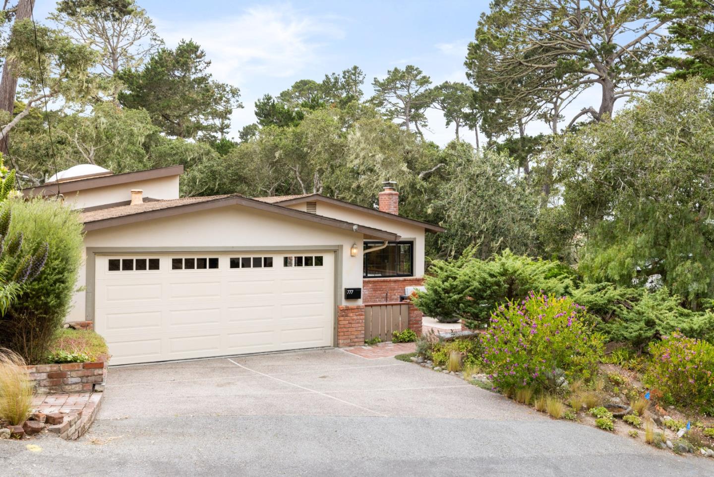 777 Parcel Street Monterey, CA 93940 - Photo 1 of 21 a view of a house with a garage and yard