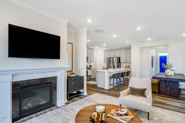 a living room with furniture a flat screen tv and a fireplace