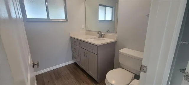 a bathroom with a sink a toilet and a mirror