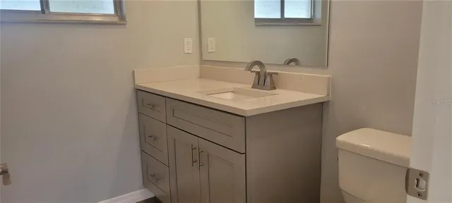 a bathroom with a sink toilet and mirror