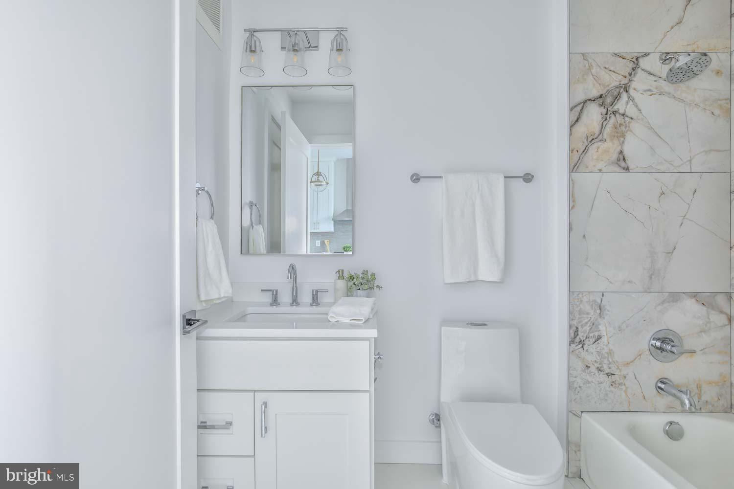 4347 Harrison Street Northwest, Unit 4 Washington, DC 20015 - Photo 14 of 16 a bathroom with a sink a toilet and bathtub