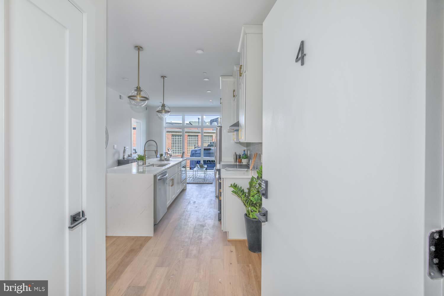 4347 Harrison Street Northwest, Unit 4 Washington, DC 20015 - Photo 2 of 16 a kitchen with counter top space and wooden floor