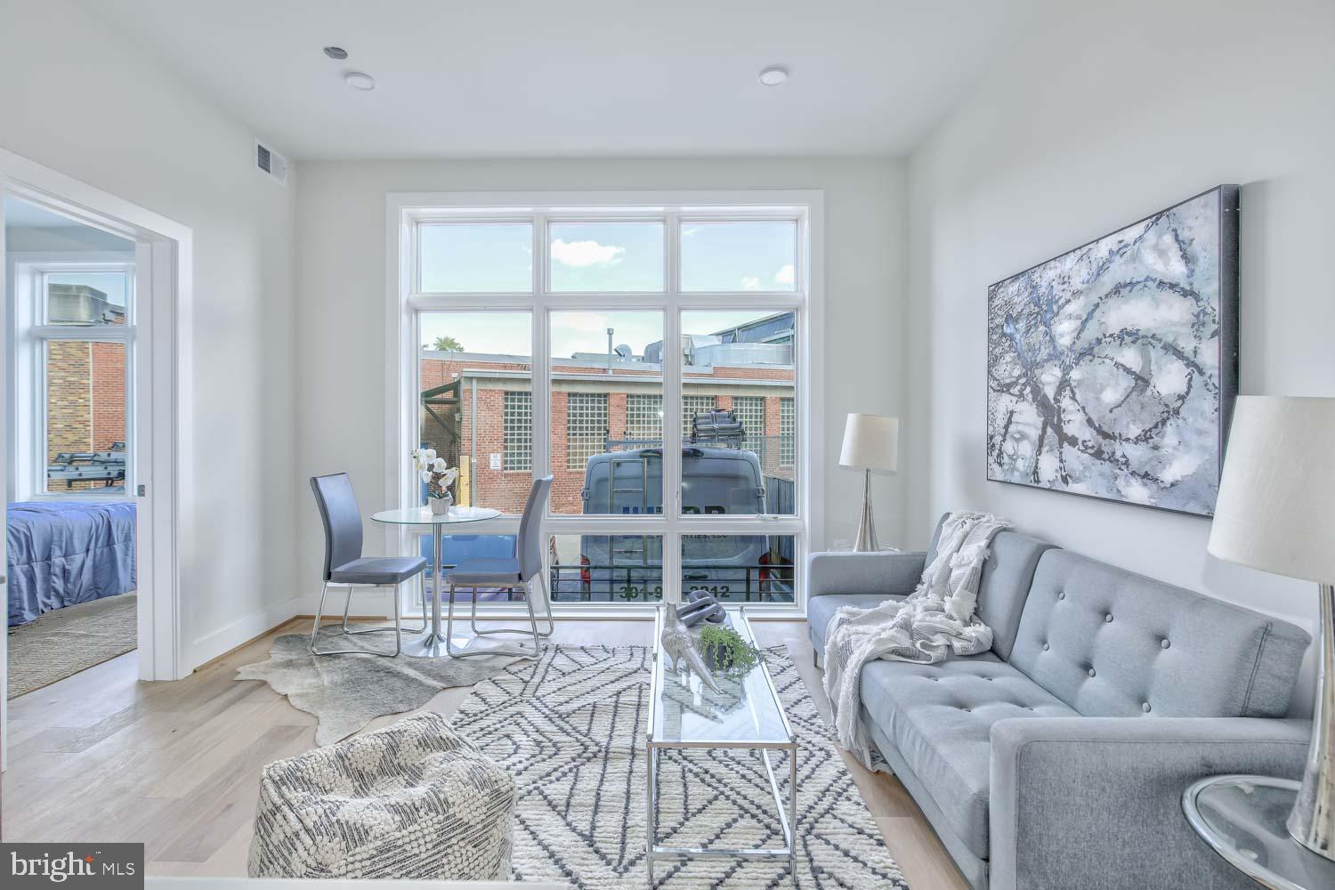 4347 Harrison Street Northwest, Unit 4 Washington, DC 20015 - Photo 5 of 16 a living room with furniture and a large window