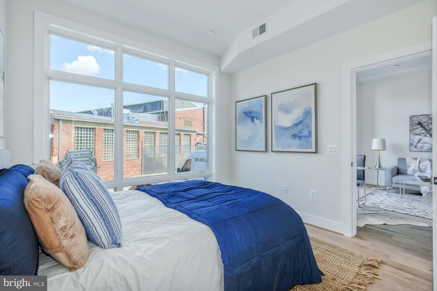 4347 Harrison Street Northwest, Unit 4 Washington, DC 20015 - Photo 10 of 16 a bedroom with a large bed and a window