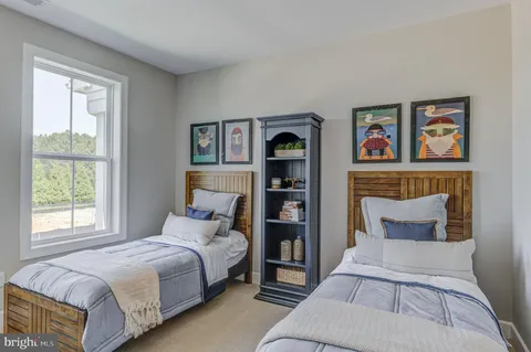 a bedroom with a bed and painting on the wall