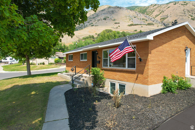 120 North 1230 E Street Springville, UT 84663 - Photo 1 of 60 Brick exterior with a large picture window, concrete walkway, and established landscaping
