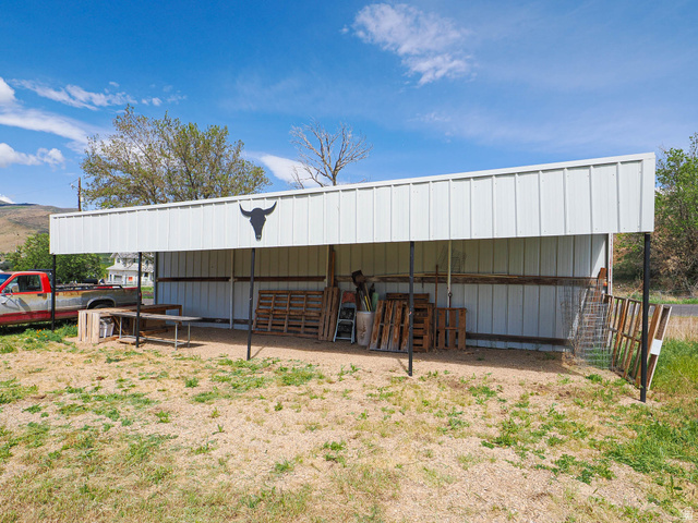 94 Spring Canyon Road Coalville, UT 84017 - Photo 12 of 50 Open-sided metal shed featuring a peaked roof and a gravel floor