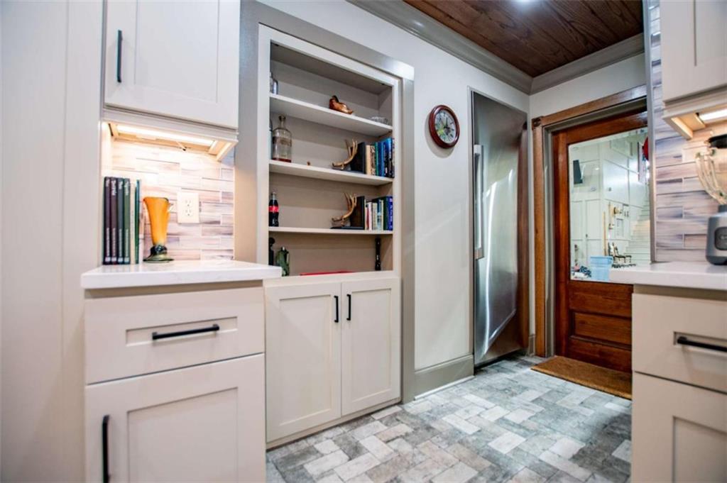 2070 Lovvorn Road Carrollton, GA 30117 - Photo 33 of 98 a kitchen with a refrigerator and white cabinets