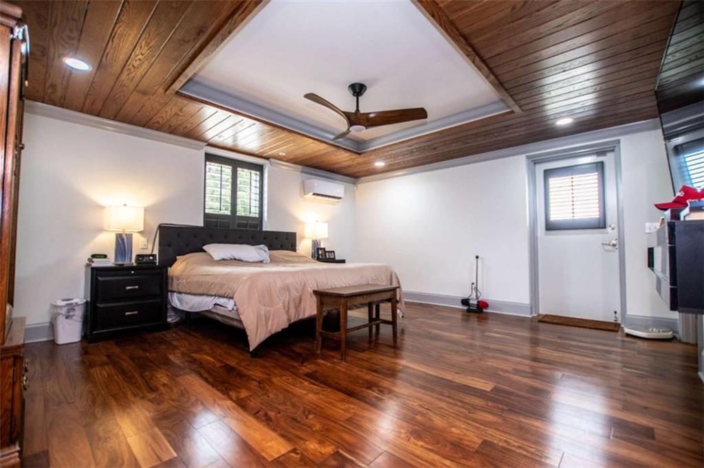 2070 Lovvorn Road Carrollton, GA 30117 - Photo 44 of 98 a spacious bedroom with a bed and a chandelier