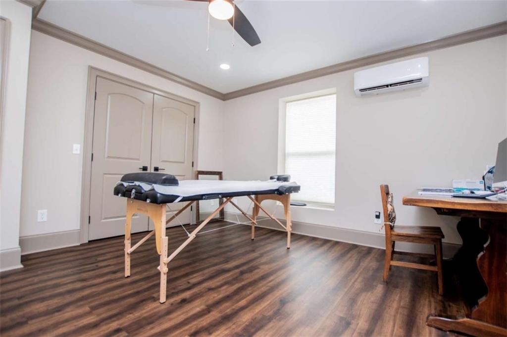 2070 Lovvorn Road Carrollton, GA 30117 - Photo 77 of 98 a view of a workspace with furniture and wooden floor