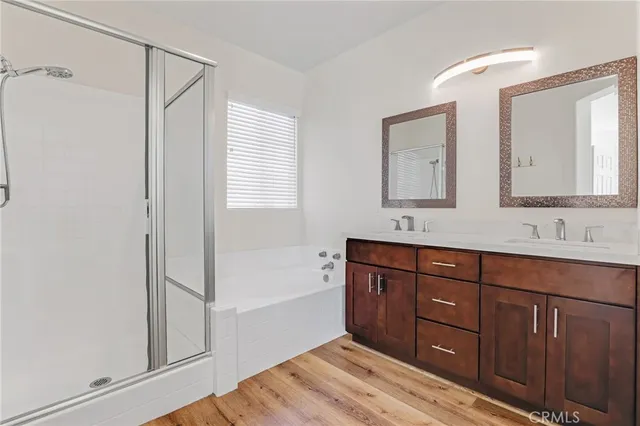 a spacious bathroom with a tub sink and mirror