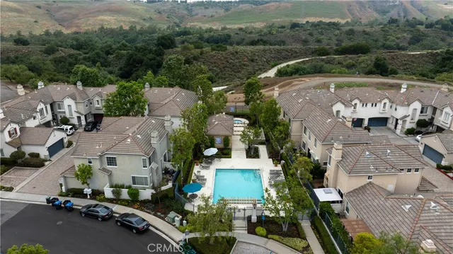 an aerial view of multiple houses with a street