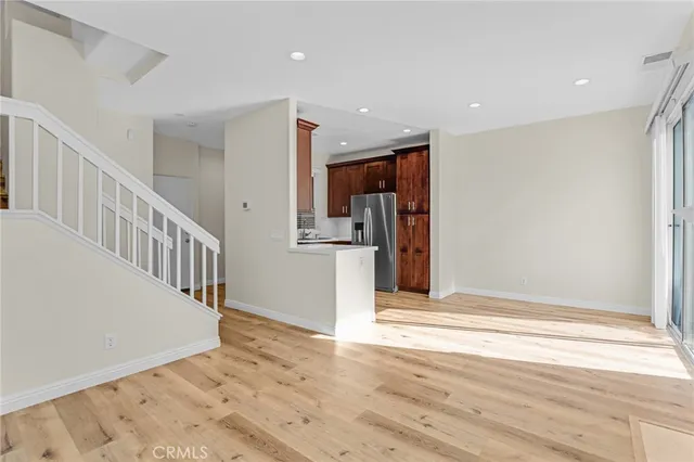a view of a kitchen with wooden floor and stairs
