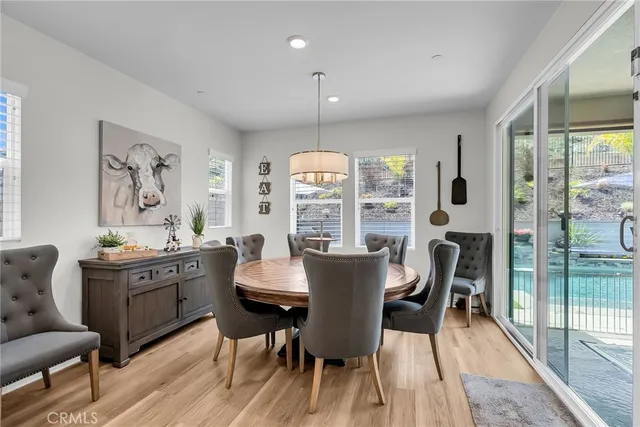 a view of a dining room with furniture wooden floor and a chandelier
