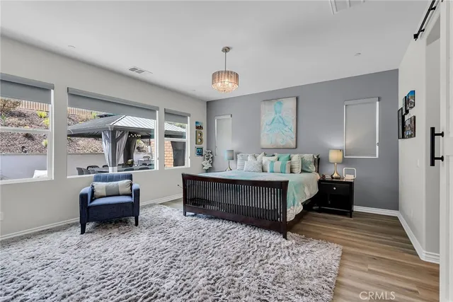 a bedroom with furniture and wooden floor
