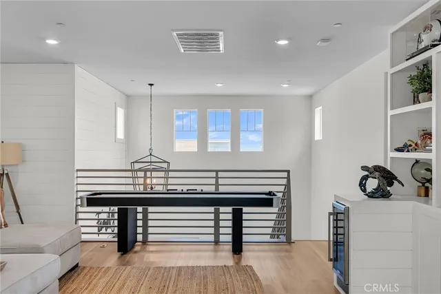 a kitchen with a sink a cabinets and wooden floor