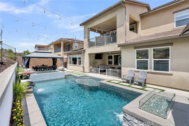 a living room with fireplace furniture and a rug