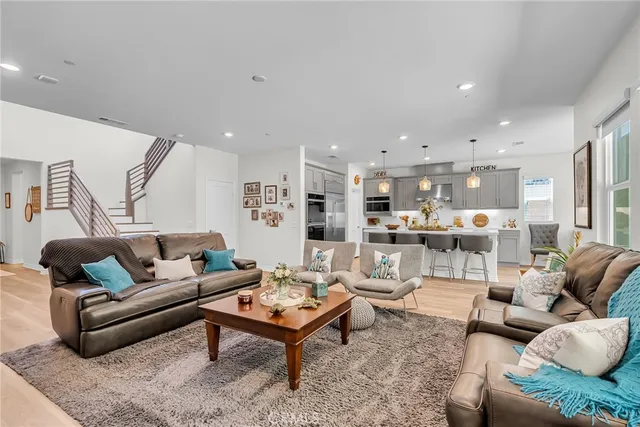 a living room with furniture kitchen view and a table