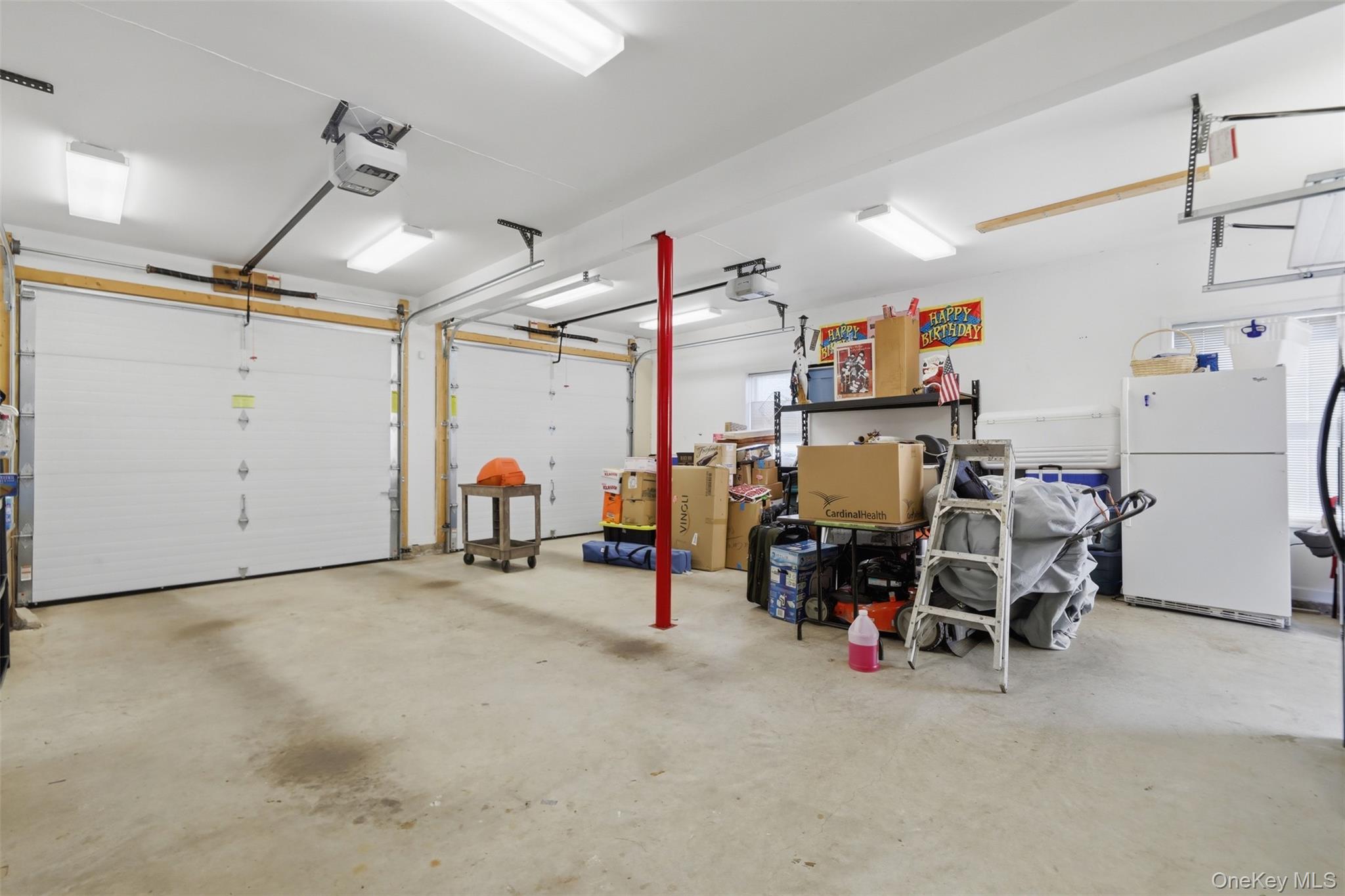 1 Hiko Place Fishkill, NY 12524 - Photo 27 of 41 Two-car garage featuring automatic openers, concrete flooring, and fluorescent lighting
