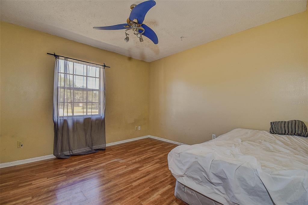 11425 Sun Road Dade City, FL 33525 - Photo 17 of 41 a bedroom with a bed and a window