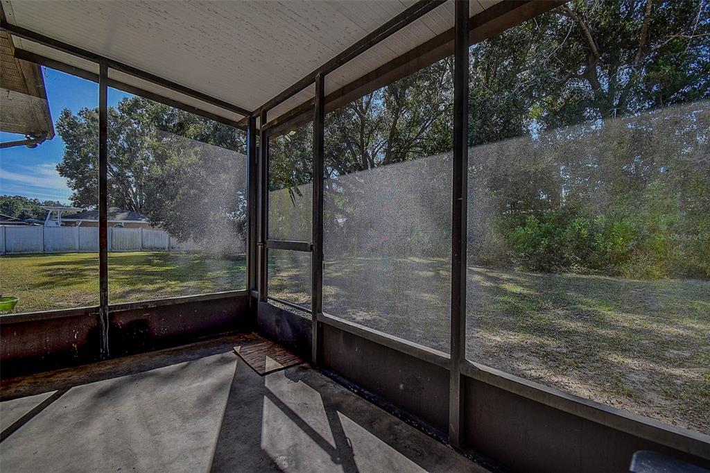 11425 Sun Road Dade City, FL 33525 - Photo 30 of 41 a view of a balcony with floor to ceiling windows with wooden floor