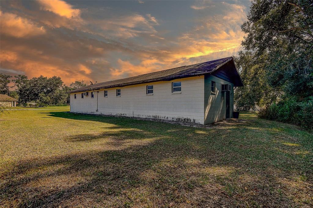 11425 Sun Road Dade City, FL 33525 - Photo 34 of 41 a backyard of a house with lots of green space and lake view