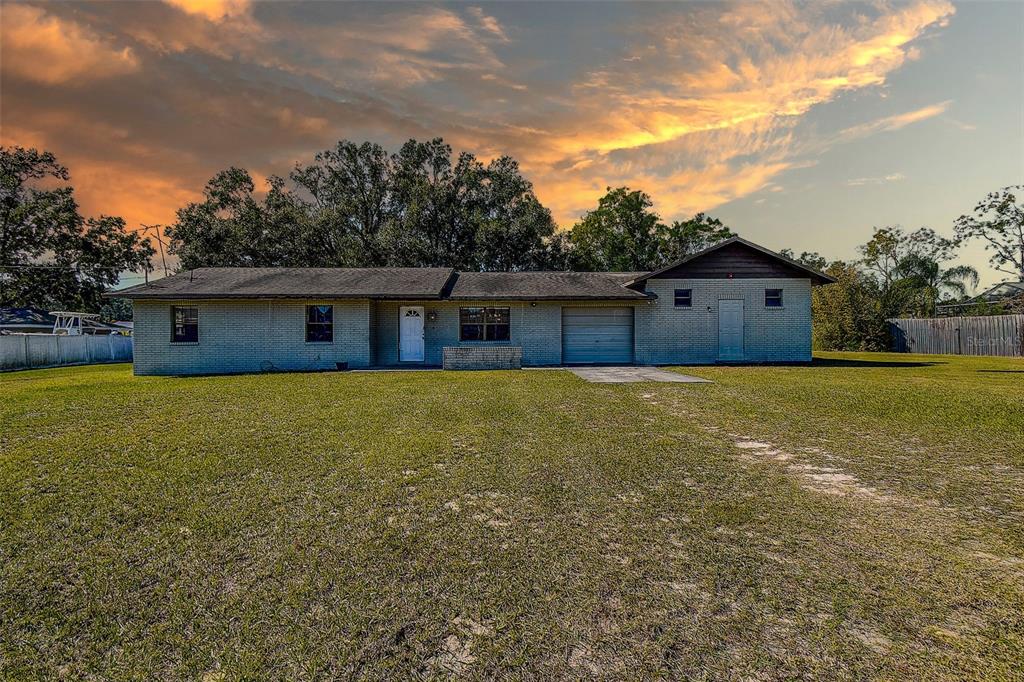 11425 Sun Road Dade City, FL 33525 - Photo 35 of 41 a view of a house with a yard
