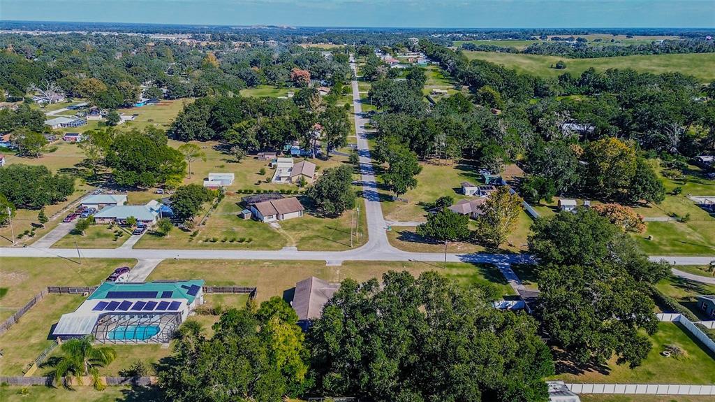 11425 Sun Road Dade City, FL 33525 - Photo 39 of 41 an aerial view of residential houses with outdoor space and trees