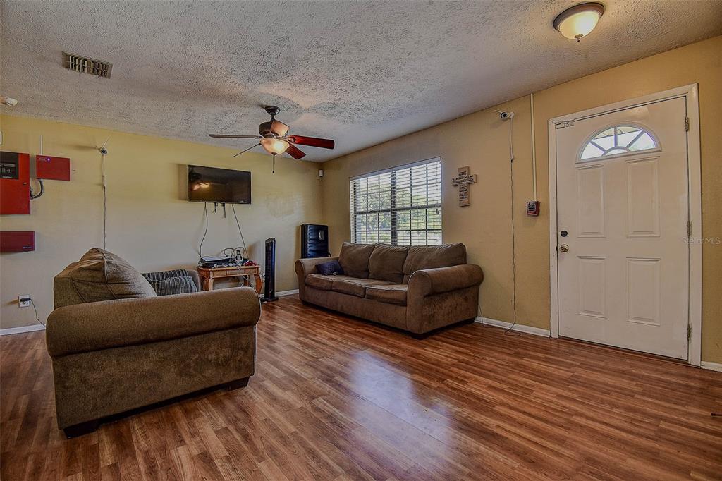 11425 Sun Road Dade City, FL 33525 - Photo 6 of 41 a living room with furniture and a wooden floor