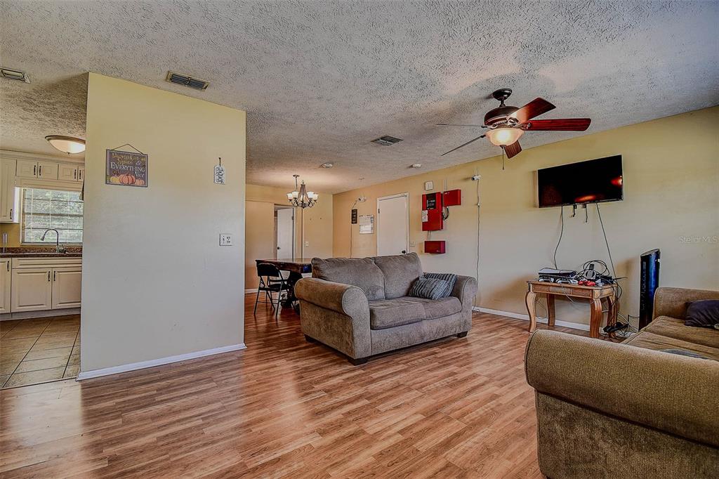 11425 Sun Road Dade City, FL 33525 - Photo 7 of 41 a living room with furniture and a flat screen tv
