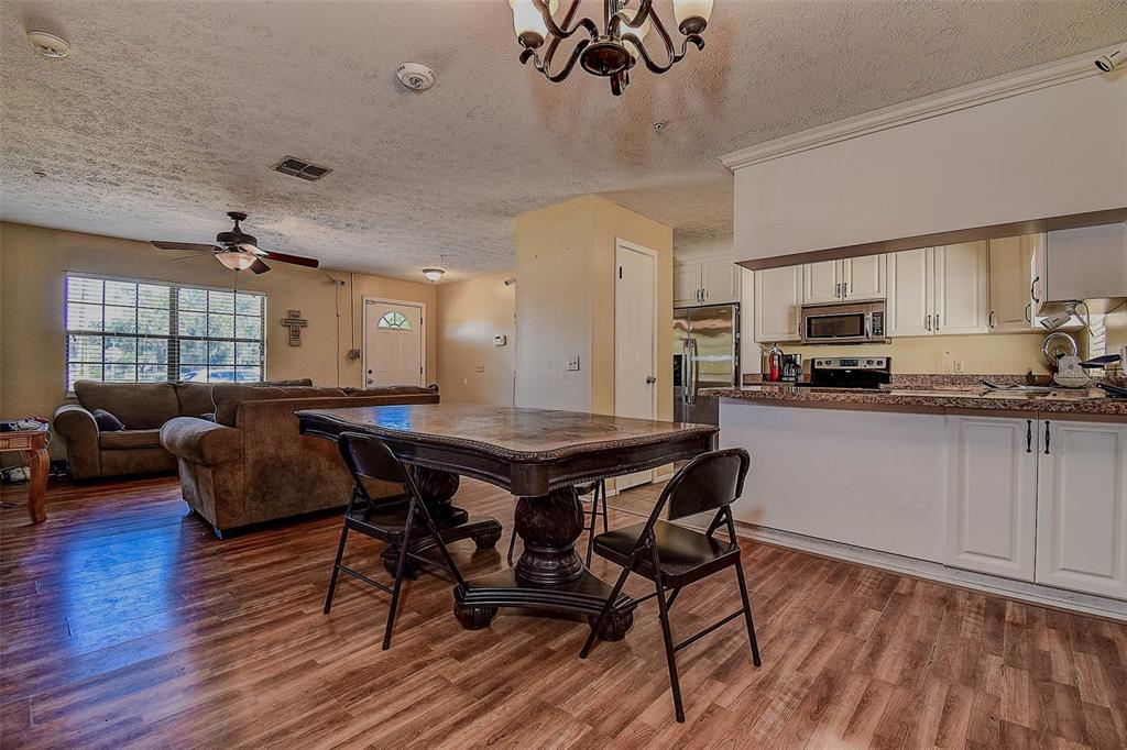 11425 Sun Road Dade City, FL 33525 - Photo 9 of 41 a living room with furniture and a wooden floor