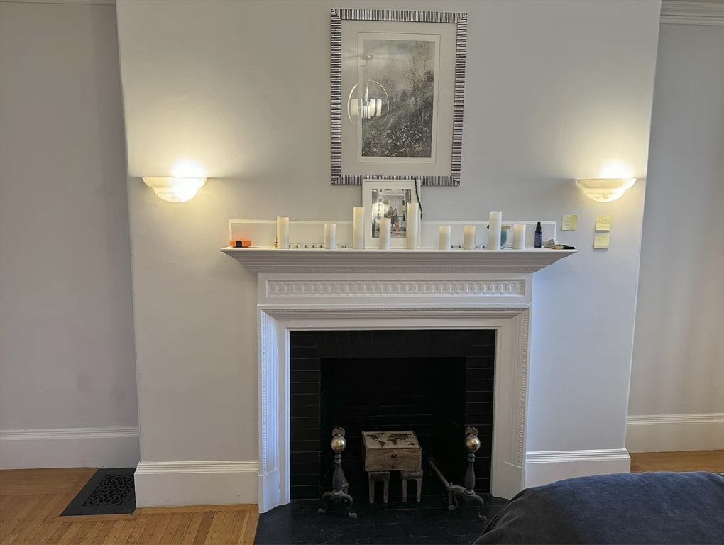 429 Marlborough Street, Unit 3A Boston, MA 02115 - Photo 12 of 21 a living room with a fireplace and wooden floor