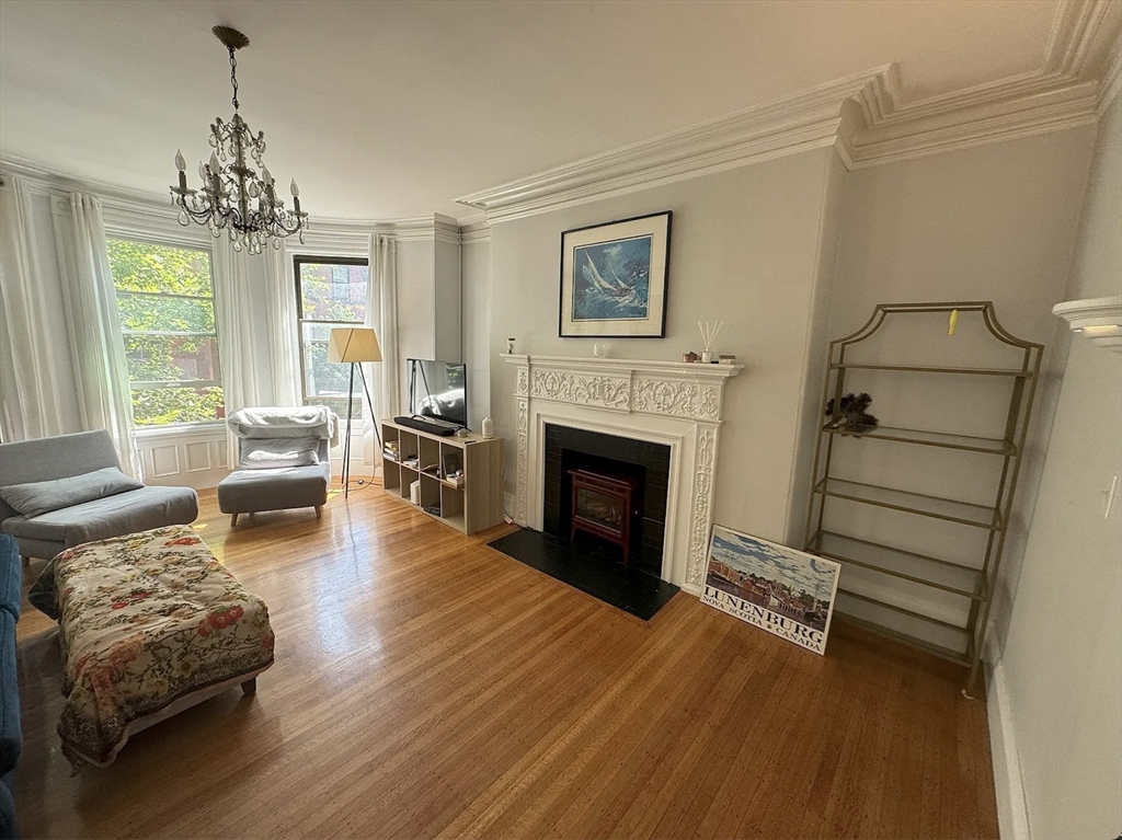 429 Marlborough Street, Unit 3A Boston, MA 02115 - Photo 13 of 21 a living room with furniture and a fireplace
