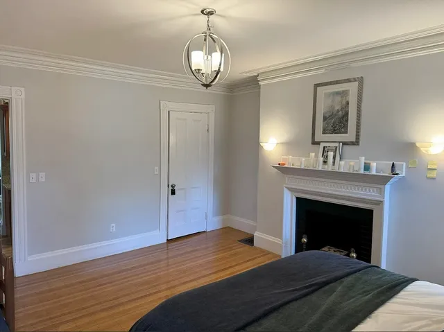 a bedroom with a bed and a fireplace