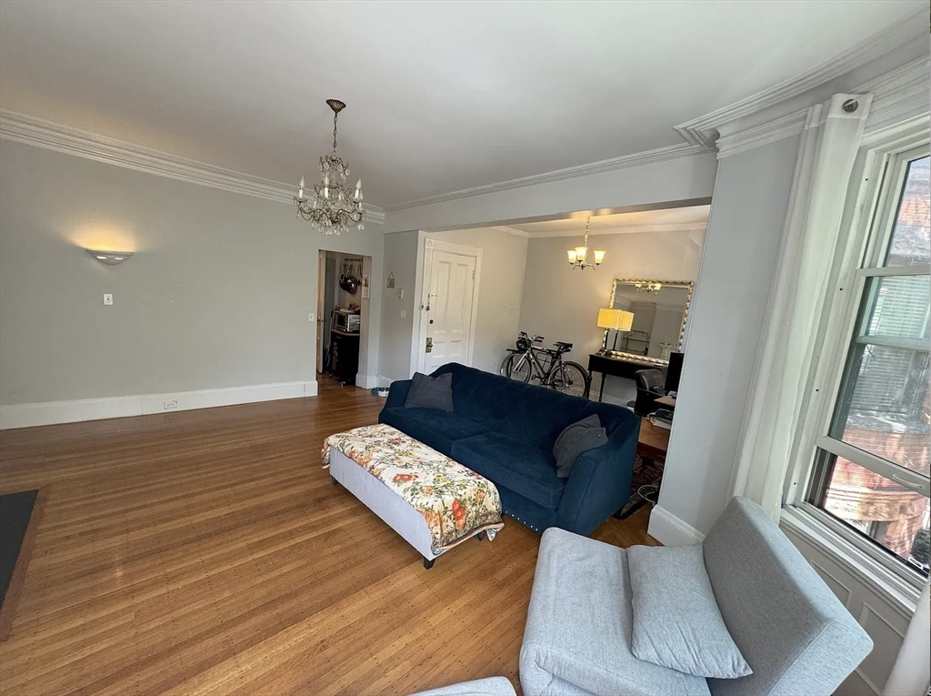429 Marlborough Street, Unit 3A Boston, MA 02115 - Photo 4 of 21 a living room with furniture and a chandelier