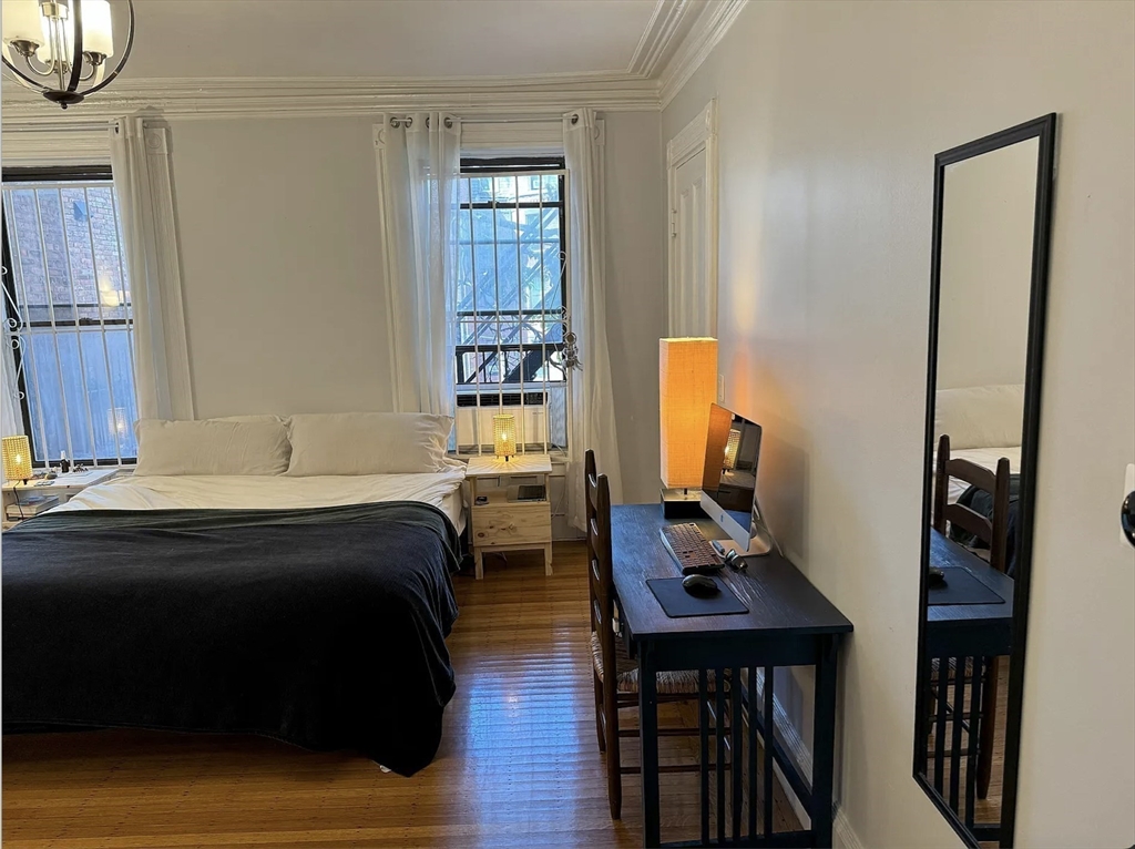 429 Marlborough Street, Unit 3A Boston, MA 02115 - Photo 6 of 21 a bedroom with a bed and wooden floor