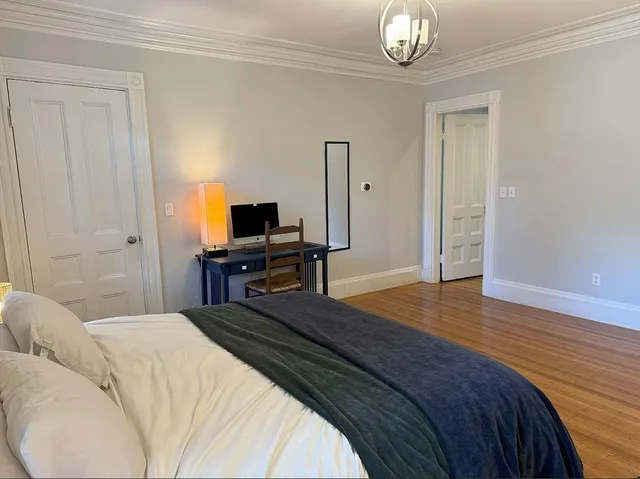 a bedroom with a bed and a table
