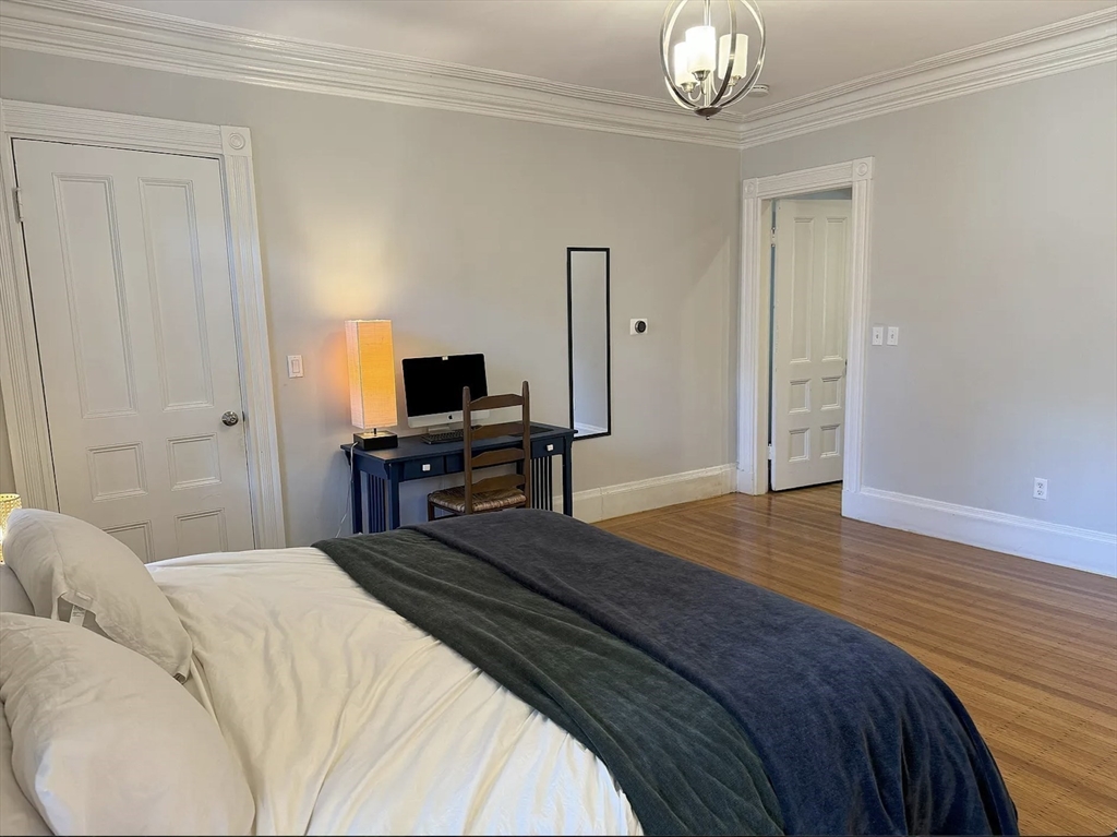 429 Marlborough Street, Unit 3A Boston, MA 02115 - Photo 7 of 21 a bedroom with a bed and a table