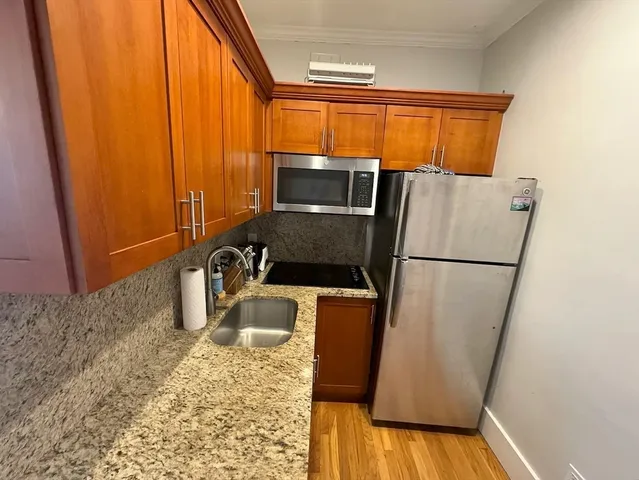 a kitchen with a refrigerator and a stove