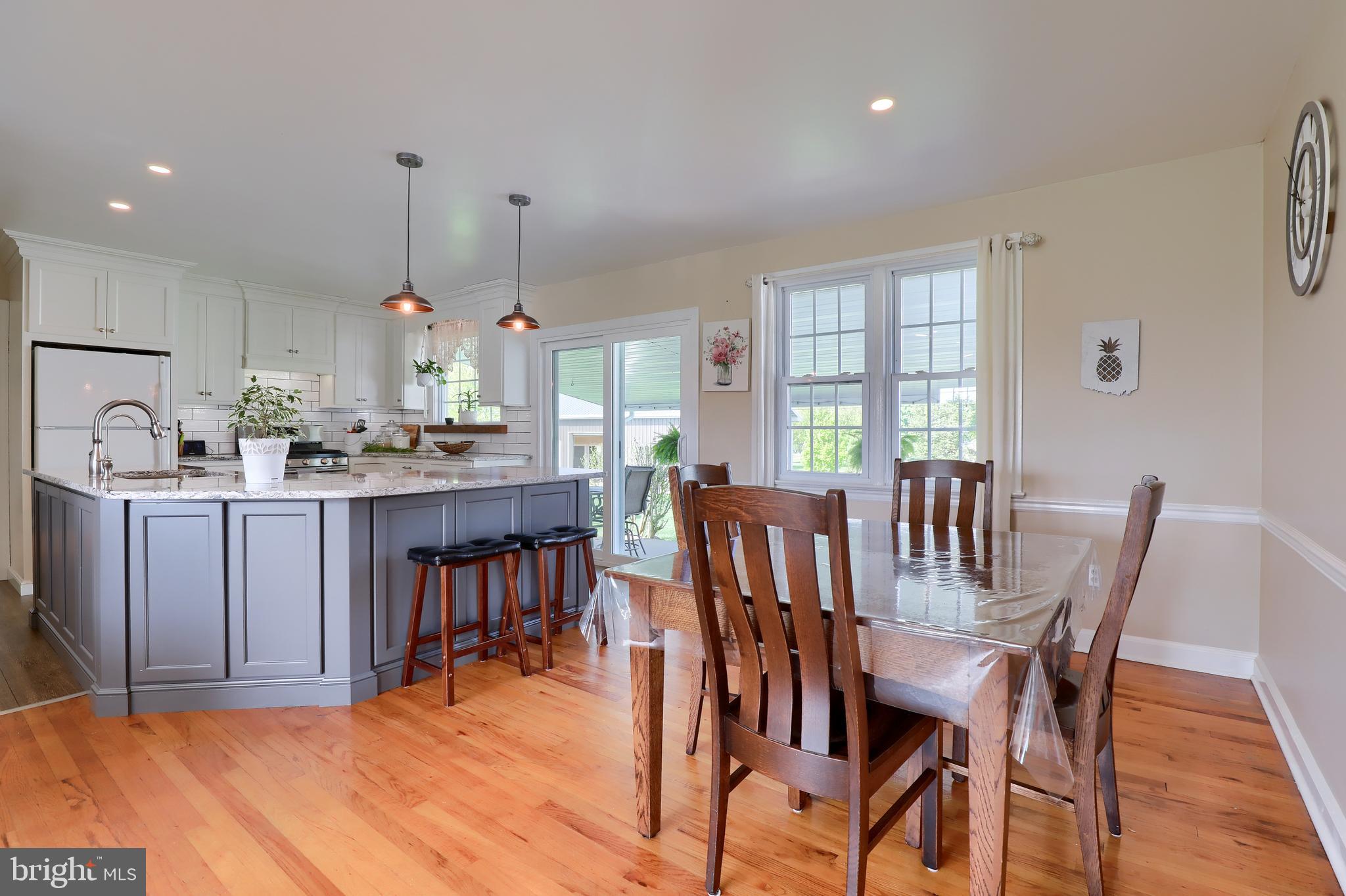 1913 Mine Road Paradise, PA 17562 - Photo 11 of 53 a kitchen with stainless steel appliances granite countertop a dining table chairs and granite counter tops