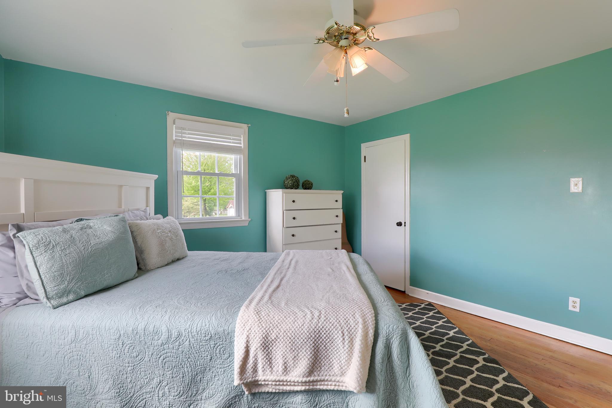 1913 Mine Road Paradise, PA 17562 - Photo 21 of 53 a bedroom with a large bed and a chandelier
