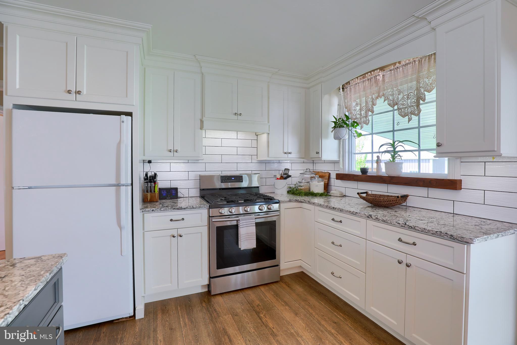 1913 Mine Road Paradise, PA 17562 - Photo 5 of 53 a kitchen with granite countertop white cabinets and white appliances
