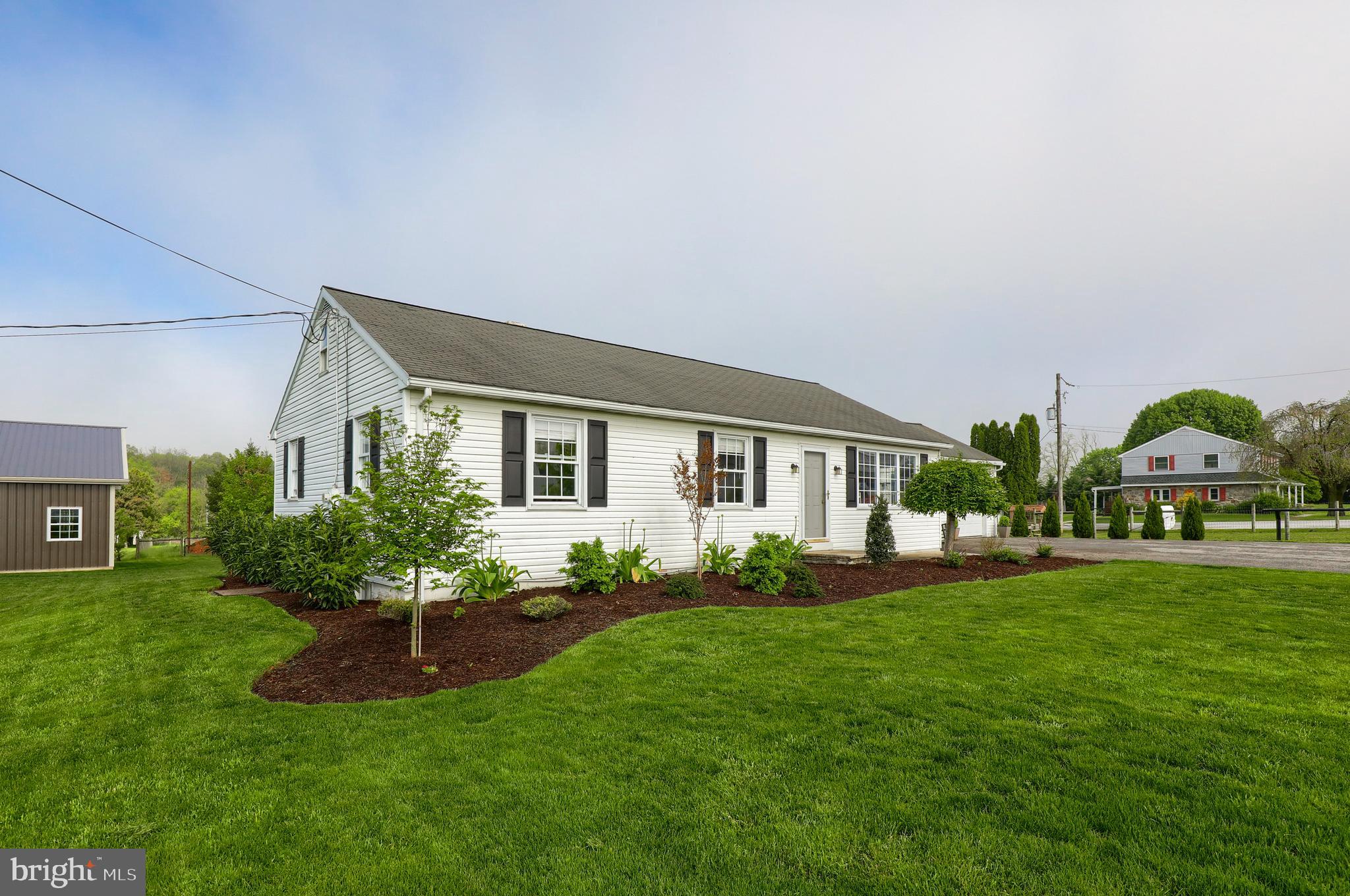 1913 Mine Road Paradise, PA 17562 - Photo 52 of 53 a front view of a house with a garden and plants