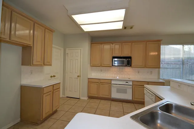 a kitchen with stainless steel appliances a refrigerator stove and sink