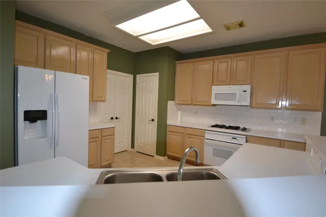 a kitchen with a sink stove and cabinets